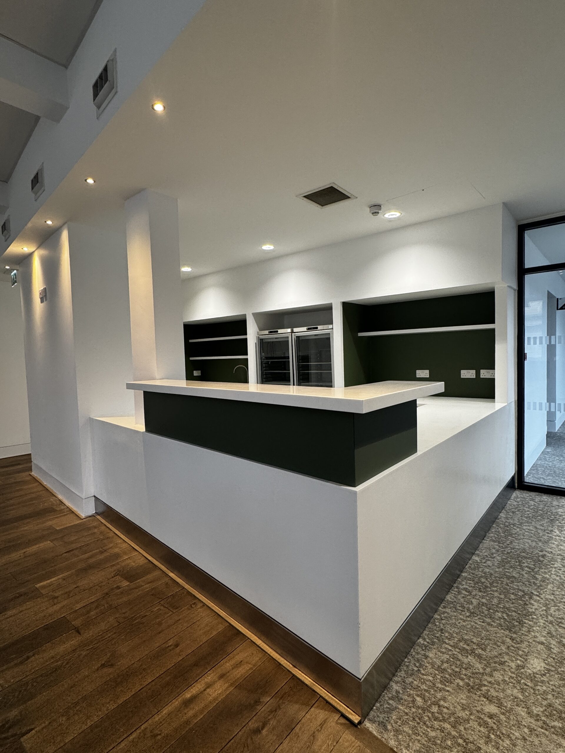 Office kitchenette wrapped in Bodaq Olive Green RM20 – architectural vinyl for walls and units.